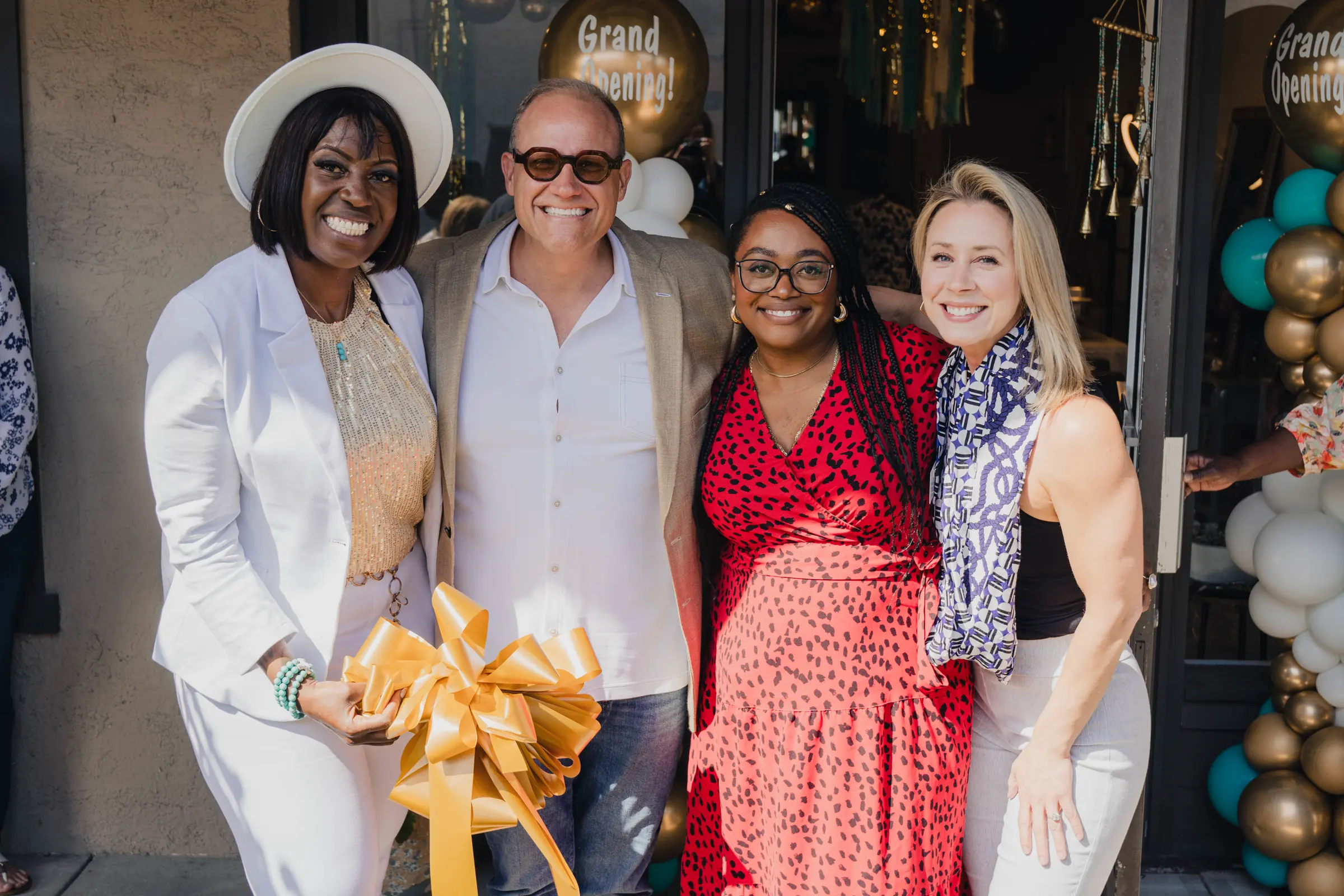 Business owners at a Grand Opening ribbon cutting